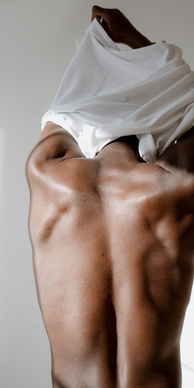 Man performing a standing hamstring stretch.