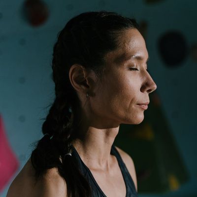 Side profile of a person taking a deep breath before exercise.